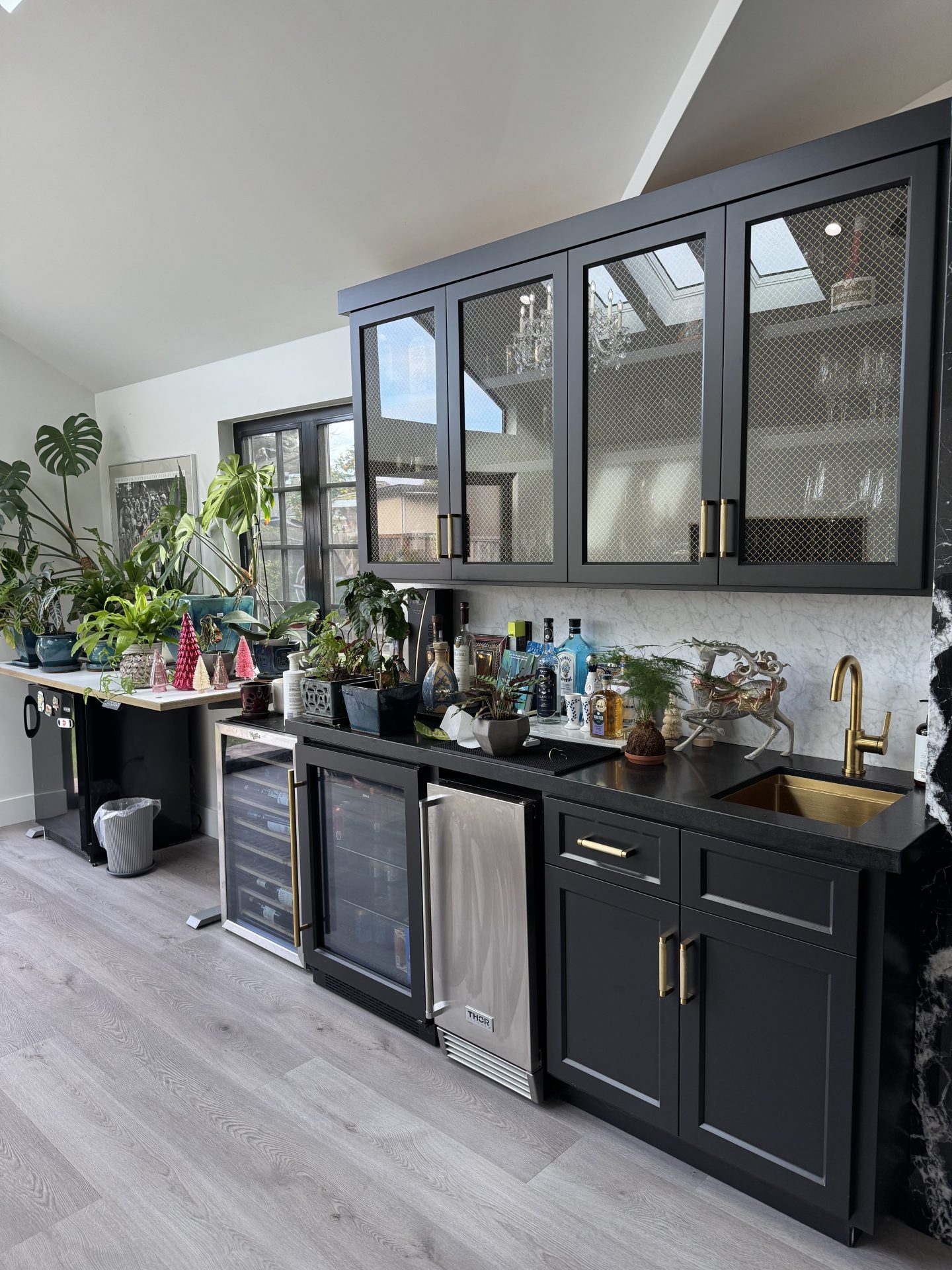 Modern beverage center with mesh cabinet fronts and integrated wine storage in Blacow Ranch home