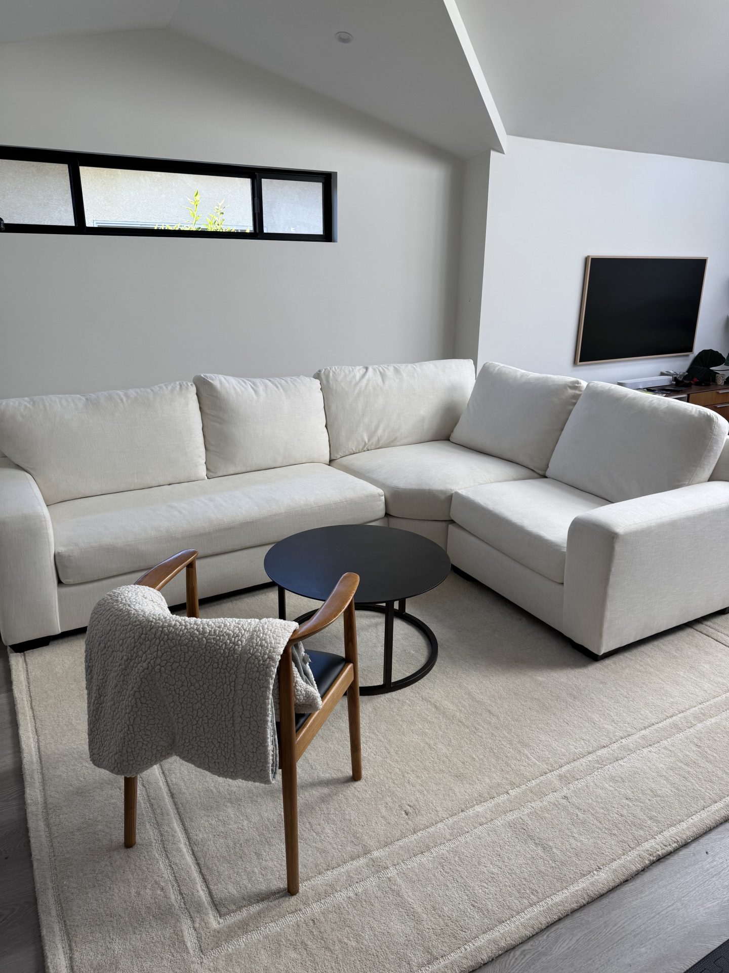 Neutral lounge corner with white sectional in a modern Fremont home renovation