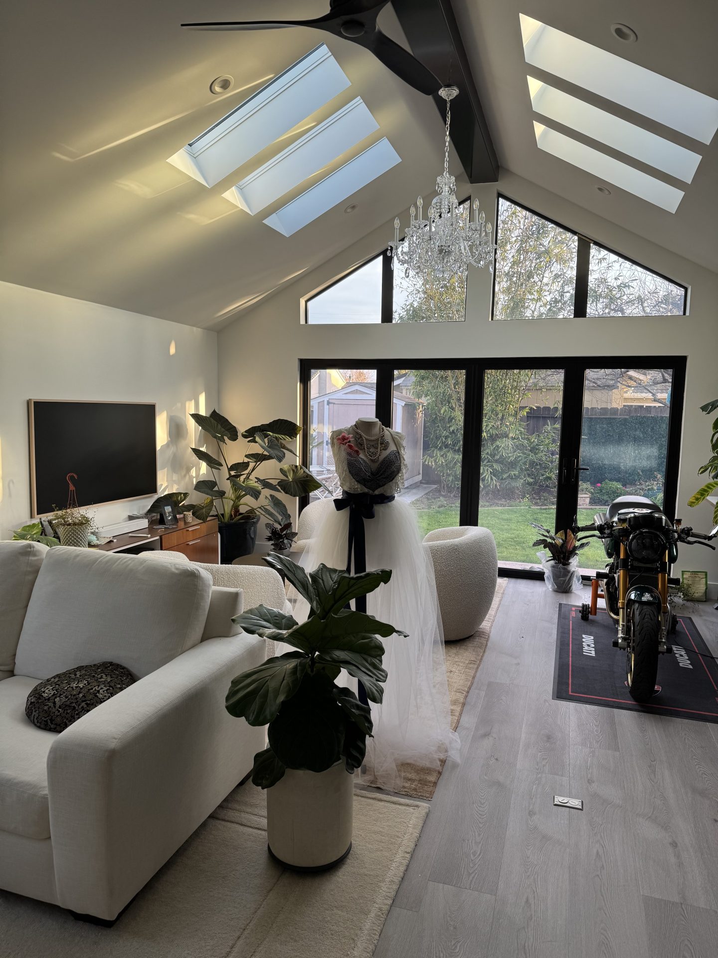 Modern great room in Blacow Ranch with vaulted ceilings, skylights, and indoor–outdoor connection