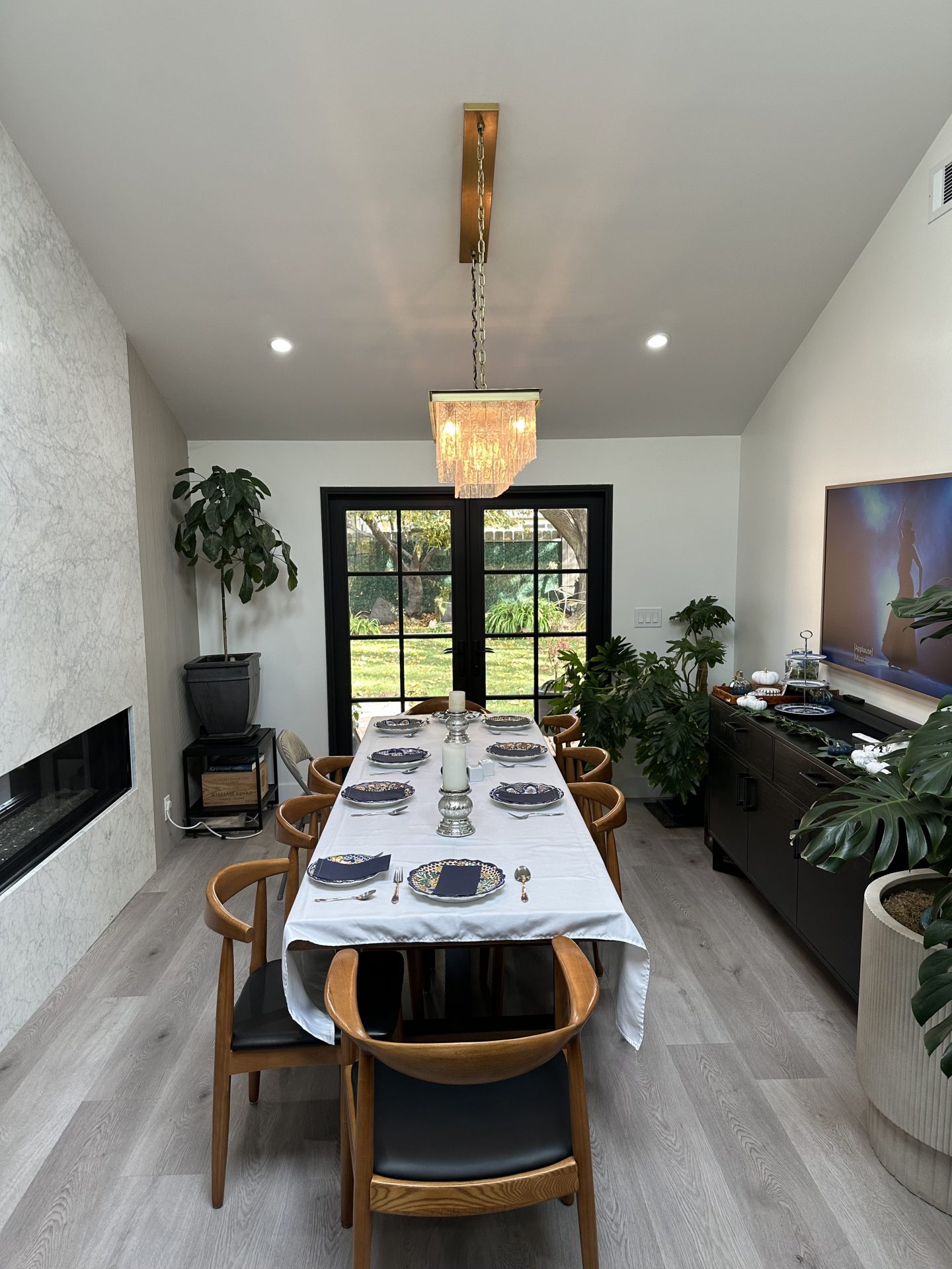 Elegant dining room with marble fireplace and French doors in Blacow Ranch home
